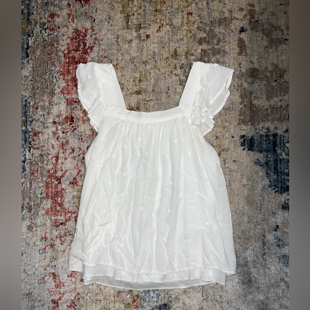 White blouse with embroidered polka dots on it